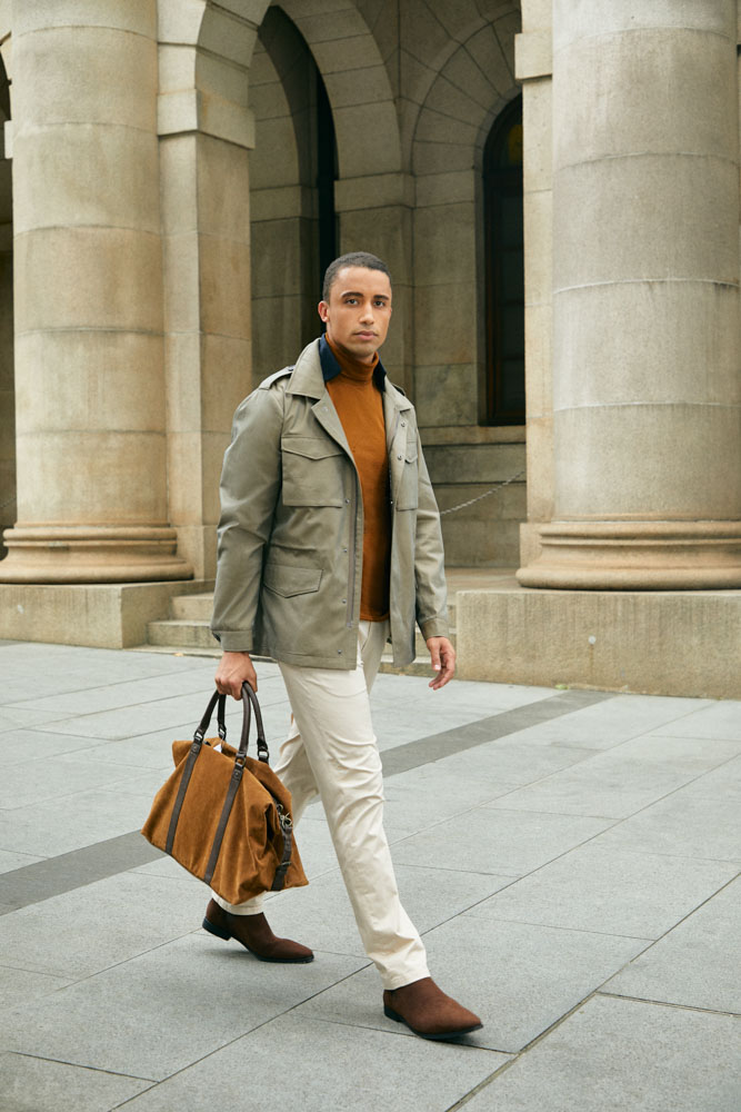 Model in Senszio custom tailored casual wear, including cream chinos and a field jacket